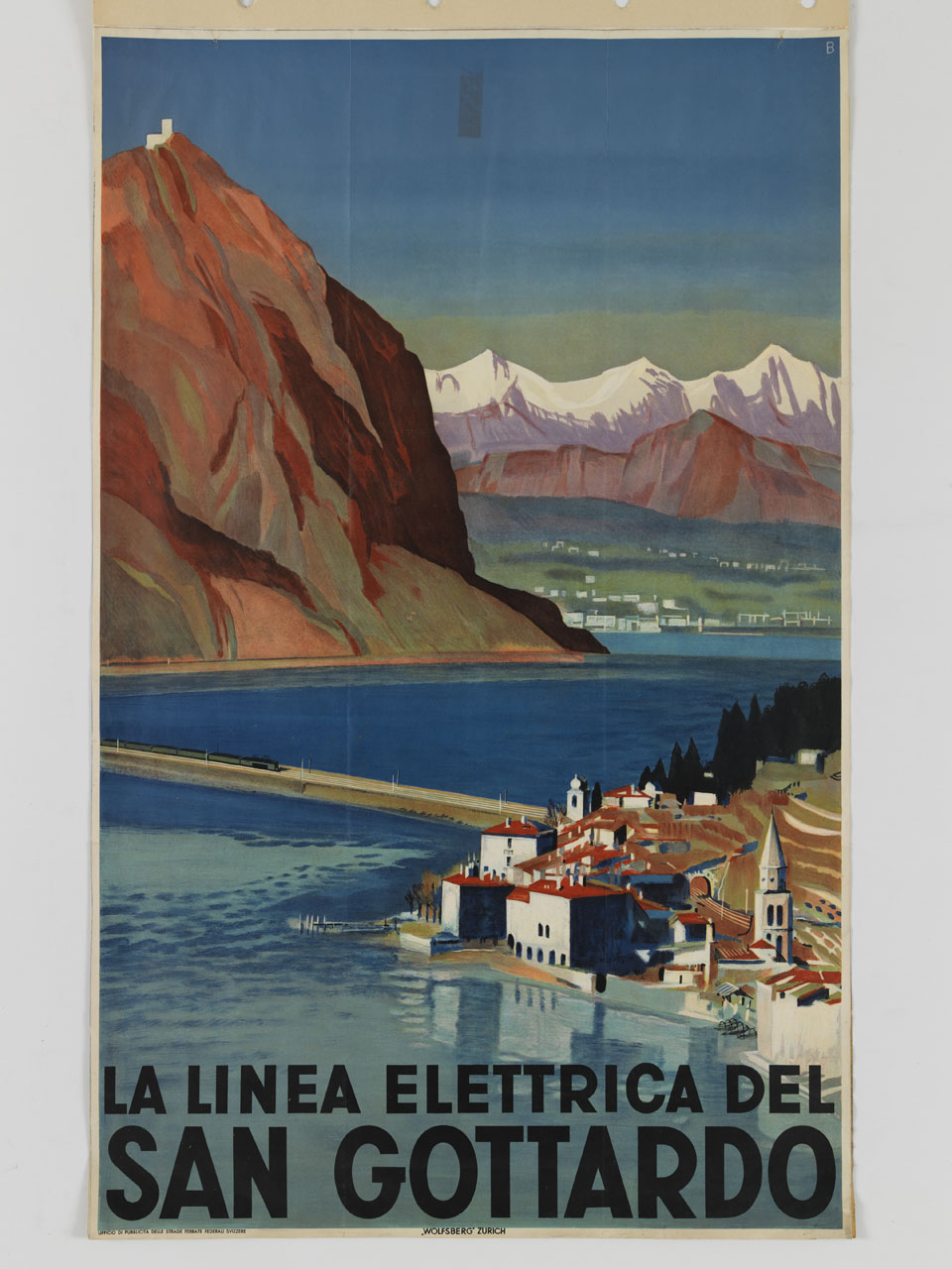 veduta di città in riva al lago con treno che attraversa un ponte e montagne sullo sfondo (manifesto) - ambito svizzero (sec. XX)