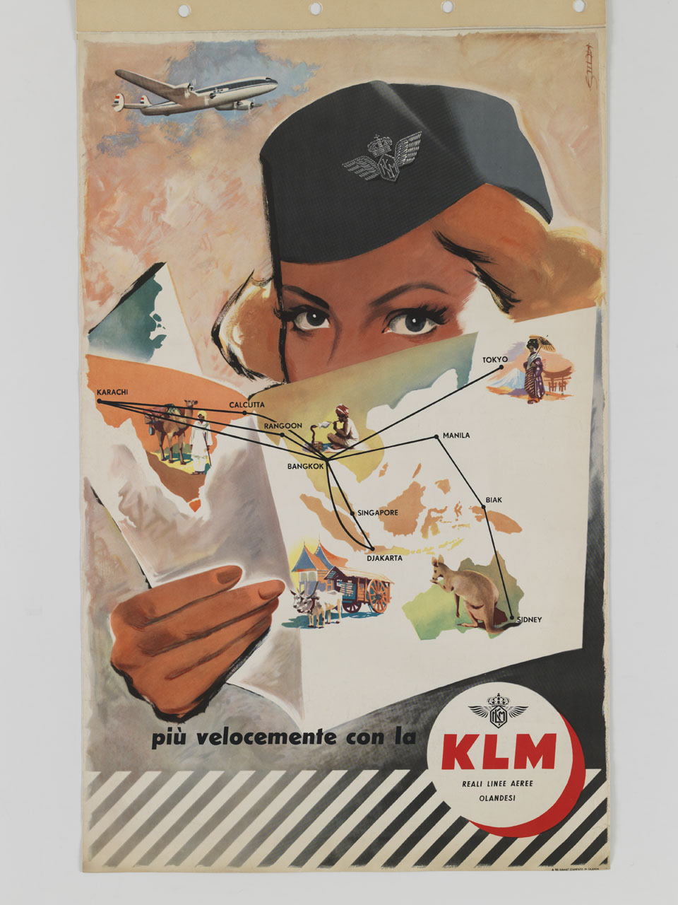 una hostess tiene in mano un pieghevole con le rotte asiatiche sullo sfondo di un aeroplano in volo (manifesto) - ambito olandese (sec. XX)