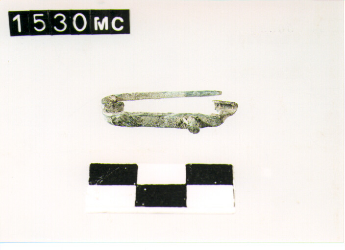 FIBULA CON ARCO A NASTRO - CULTURA TOMBE A FOSSA (SEC. VIII A.C)