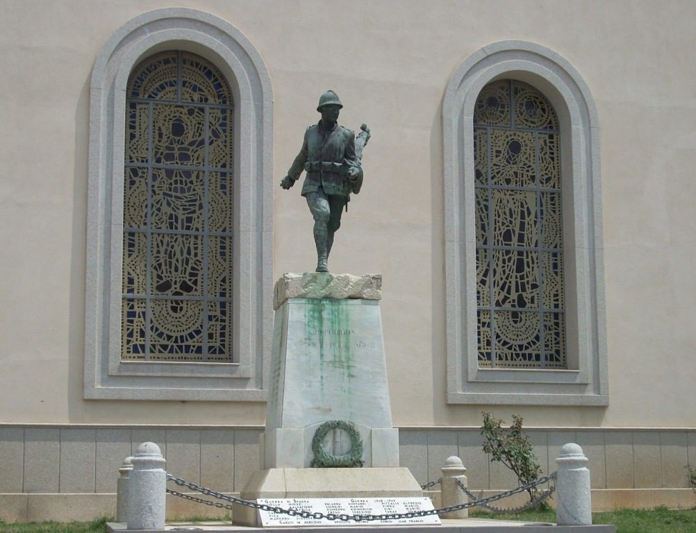 Figura di soldato in combattimento che porta la bandiera (monumento ai caduti - a cippo)