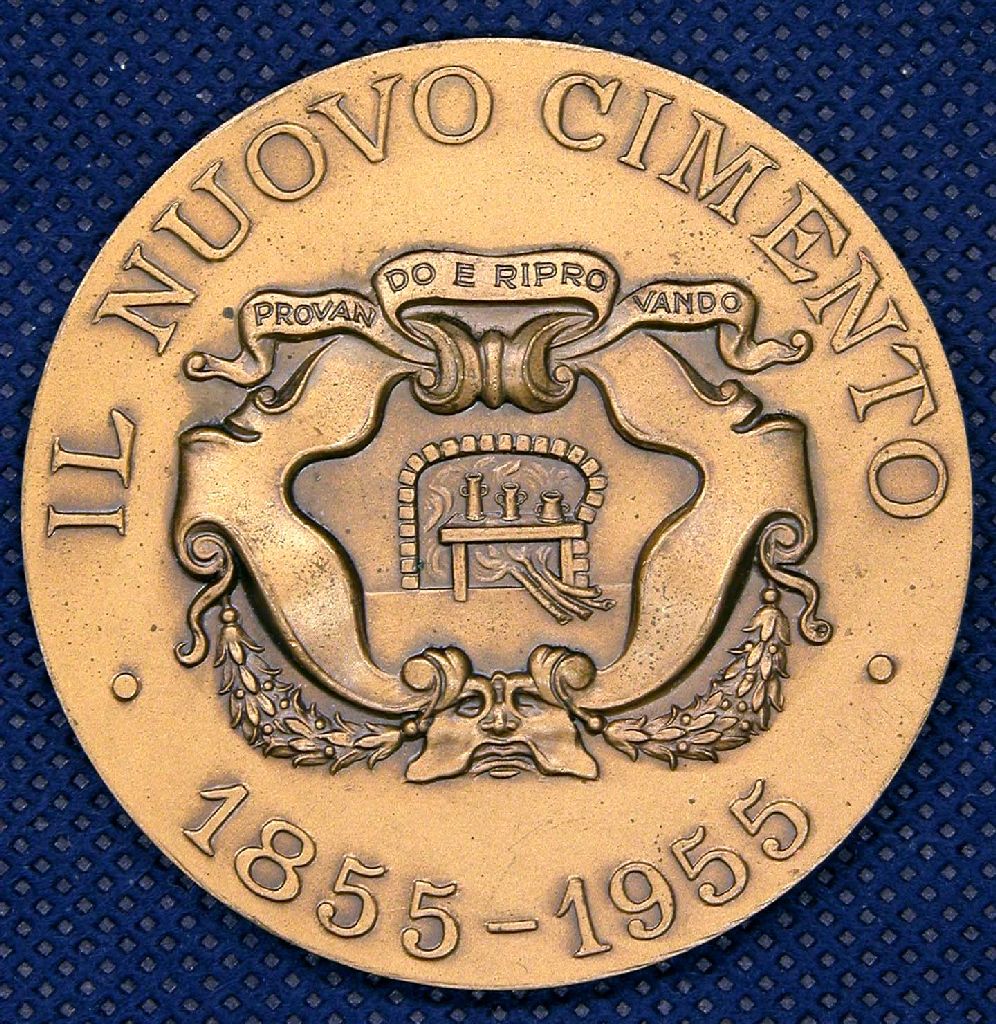 Diritto: Forno e recipienti in un ornato con nastro ; Rovescio: iscrizione con nel mezzo Cherubino e scudo con Croce Pisana  (medaglia) di Picchiani, Barlacchi (sec. XX)