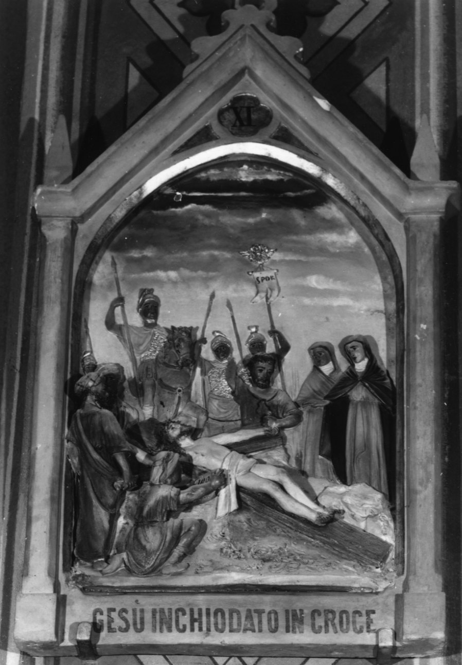 stazione XI: Gesù inchiodato alla croce (formella) - ambito piemontese (terzo quarto sec. XIX)