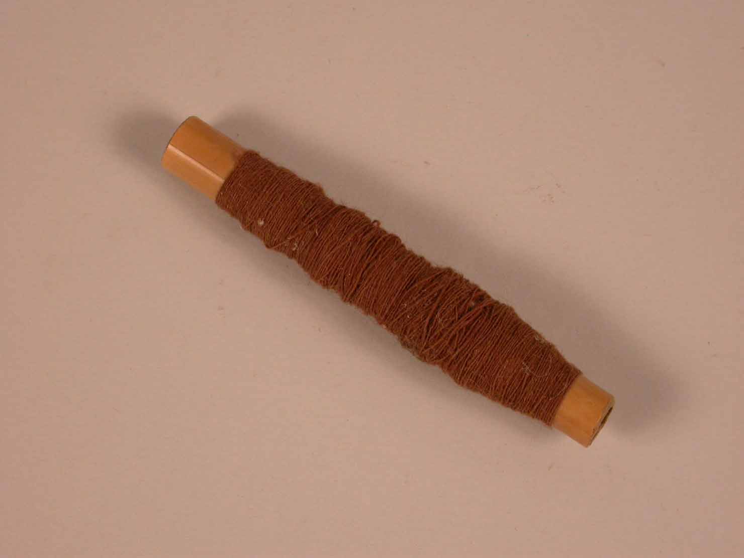 filo marrone con spola, strumento da laboratorio - manifattura conventuale (sec. XIX)