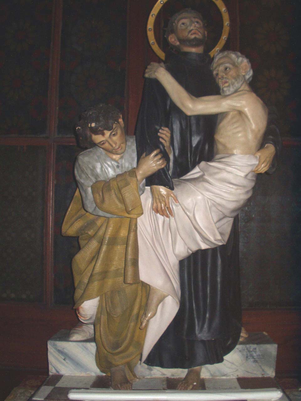 San Giovanni di Dio cura gli appestati (gruppo scultoreo) di Pulli Giovanni (sec. XX)
